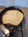 Failed pancake in the pan during baking in a kitchen with gas Royalty Free Stock Photo