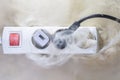 Burning of the wire cable and socket outlet plug in the house  blurred photo  concept blurred background  selective focus Royalty Free Stock Photo