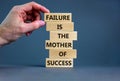 Failure or success symbol. Wooden blocks with words A failure is the mother of success. Beautiful grey table grey background.