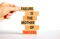 Failure or success symbol. Wooden blocks with words A failure is the mother of success. Beautiful white table white background. Royalty Free Stock Photo