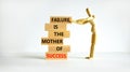 Failure or success symbol. Wooden blocks with words A failure is the mother of success. Beautiful white table white background.