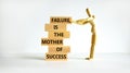 Failure or success symbol. Wooden blocks with words A failure is the mother of success. Beautiful white table white background.