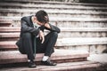 Failure unemployed stressed young Asian business man in suit covering head with hands. A young businessman sitting desperate on Royalty Free Stock Photo