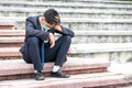 Failure unemployed stressed young asian business man in suit and wearing a face mask covering head with hands. A young businessman Royalty Free Stock Photo