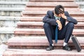 Failure unemployed stressed young asian business man in suit and wearing a face mask covering head with hands. A young businessman Royalty Free Stock Photo