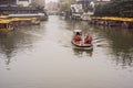 A faint foggy day, a small motor boat driving on the Qinhuai River