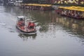 A faint foggy day, a small motor boat driving on the Qinhuai River