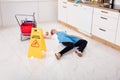 Fainted Housemaid Lying On Floor In Kitchen Royalty Free Stock Photo