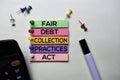 Fair Debt Collection Practices Act - FDCPA text on sticky notes isolated on office desk