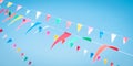 Fair flag blur bunting background hanging on blue sky for fun festa party event, summer holiday farm feast celebration, carnival
