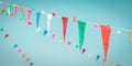 Fair flag bunting colorful background hanging on blue sky for fun fiesta party event, summer holiday farm feast celebration