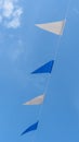 Fair flag bunting colorful background hanging on blue sky for fun fiesta party event, summer holiday farm feast celebration