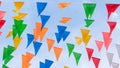 Fair flag bunting colorful background hanging on blue sky for fun fiesta party event, summer holiday farm feast celebration