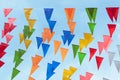 Fair flag bunting colorful background hanging on blue sky for fun fiesta party event, summer holiday farm feast celebration