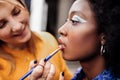 Fair-haired young stylist with black nail polish smiling nicely Royalty Free Stock Photo