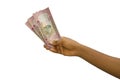 Fair hand holding 5000 Rwandan franc notes isolated on white background