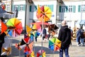 Fair at the market square in the city center, artisans sell self-made goods, shoppers stroll through the sunny city, windmills and