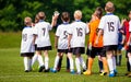 Fair Play Rules in Youth Football. Happy Football Players Giving High Five At Field. Soccer Players High Five After Game