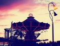 A fair ride at dusk toned with a retro vintage instagram filter effect app or action Royalty Free Stock Photo