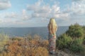 Fair seascape with blonde woman, the foreground is young slim woman with long hair, background is sea piece