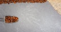 Fair trade coffee beans with burlap and spoon at grey kitchen worktop background Royalty Free Stock Photo