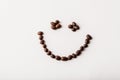 Fair trade roasted organic coffee beans arranged as a smile on w