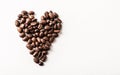 Fair trade roasted organic coffee beans shaped as a heart on whi