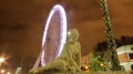 Fairground at night and a statue Royalty Free Stock Photo