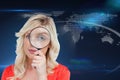 Fairhaired woman looking through a magnifying glass Royalty Free Stock Photo