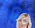 Fairhaired woman looking through a magnifying glass