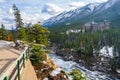 Fairmont Banff Springs and Bow River Falls in snowy autumn sunny day. Banff National Park, Canadian Rockies. Royalty Free Stock Photo