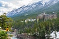Fairmont Banff Springs and Bow River Falls in snowy autumn sunny day. Banff National Park, Canadian Rockies. Royalty Free Stock Photo