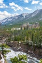 Fairmont Banff Springs and Bow River Falls in snowy autumn sunny day. Banff National Park, Canadian Rockies. Royalty Free Stock Photo