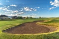 Fairway and bunker on a golf course with homes and mountain in the distance Royalty Free Stock Photo