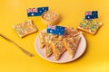 Fairy bread with butter knife, side view. The famous traditional Australian food Fairy Bread on a yellow background