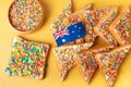 Fairy bread with butter knife, side view. The famous traditional Australian food Fairy Bread on a yellow background