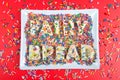 fairy-bread-spelled-rectangular-plate-bright-red-background-candy-sprinkles-spilled-commonly-served-children-s-205177066.jpg