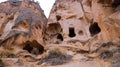 Cave houses surrounded by rock formations in Cappadocia, Turkey Royalty Free Stock Photo