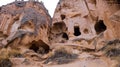 Cave houses surrounded by rock formations in Cappadocia, Turkey Royalty Free Stock Photo