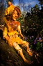 Fairy doll handmade figure sitting on stone in woodland