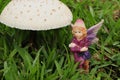 A fairy figurine and a mushroom