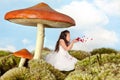 Fairy girl blowing rose petals