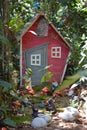 Fairy house in the woods with various gnomes, elves and other figurines