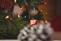 Fairy light and small gift box hanging on christmas tree Royalty Free Stock Photo