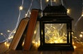 fairy lights inside old lantern and antique books