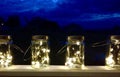 Fairy lights inside retro vintage top jars with handles