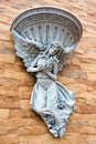Fairy statue and fountain basin decorate on the wall