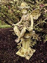 Fairy Statue on pillar in garden