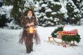 Fairy tale girl. Portrait a little girl in a deer dress with a painted face in the winter forest. Big brown antler