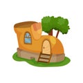 Fairy-tale house in form of yellow shoe with little window and wooden ladder in front of entrance door. Green tree on